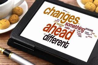 Image of portable electronic device with "changes ahead" word cloud on screen